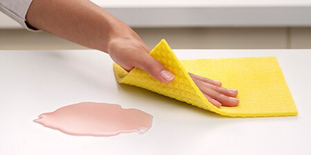 Cleaning countertop with Scotch-Brite® Sponge Cloth
