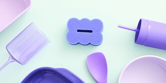 Brite by Scotch-Brite™ Dark Blue Scrub & Wipe Sponge displayed with pastel kitchen utensils on the kitchen countertop.
