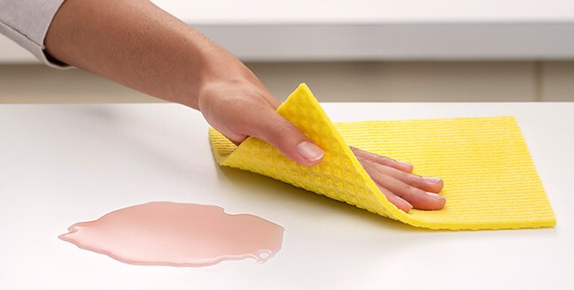 Cleaning countertop with Scotch-Brite® Sponge Cloth
